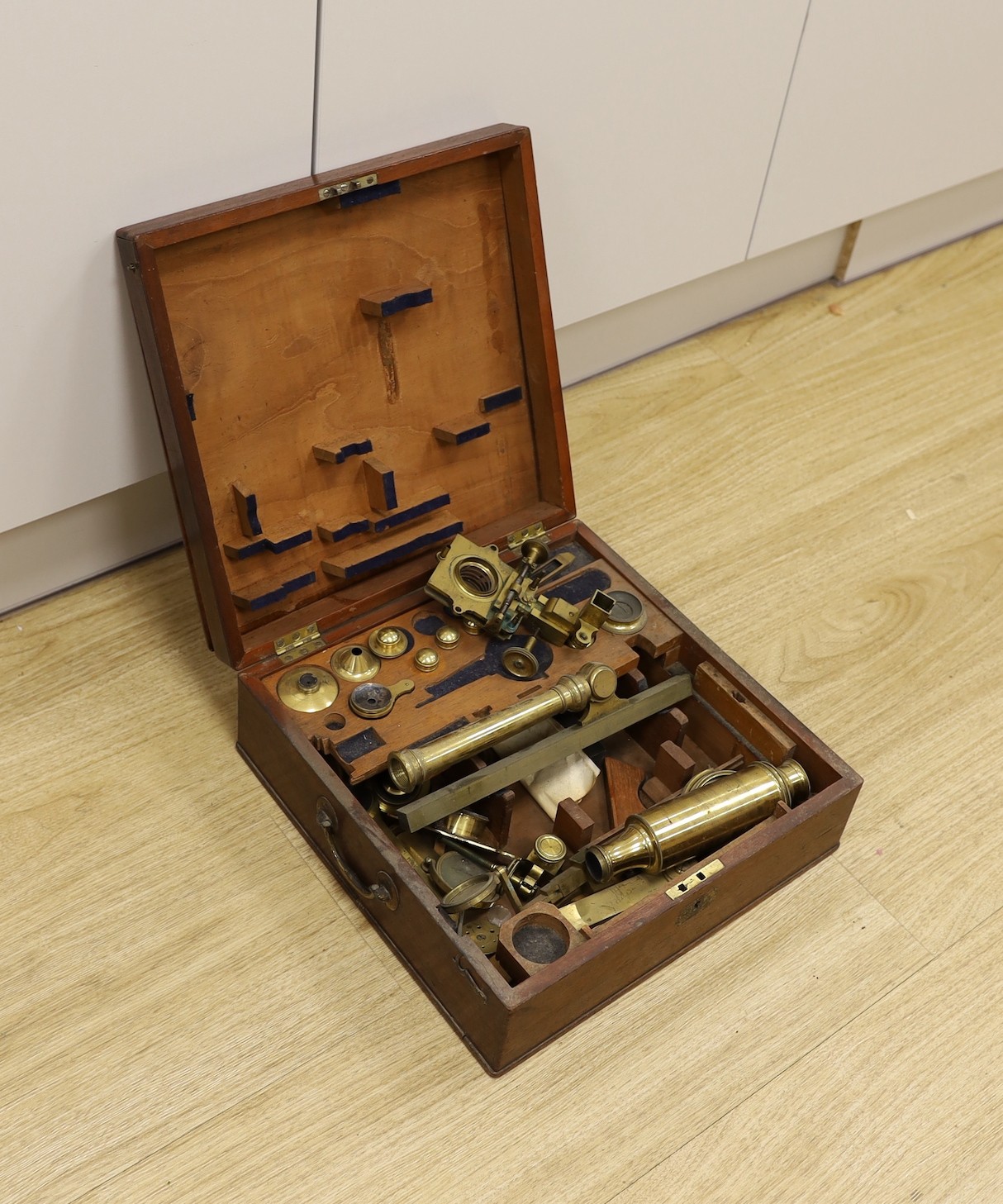 A 19th century cased brass monocular microscope